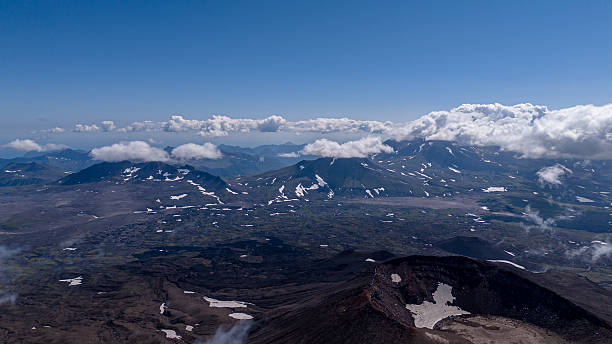 istock Panoramic view of snow capped mountains under a clear blue sky with scattered clouds 2253481957