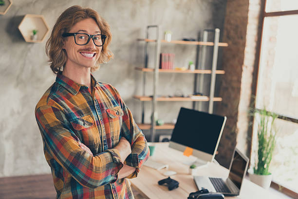 istock Photo portrait man in glasses checkered shirt folded hands professional developer at office smiling happy 2253481963