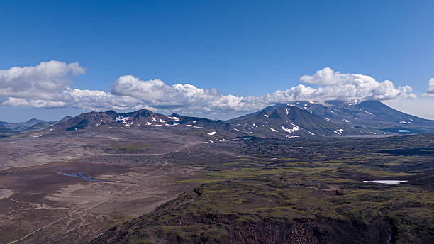 istock Mountainous landscape with snow capped peaks under a blue sky scattered with clouds 2253481976