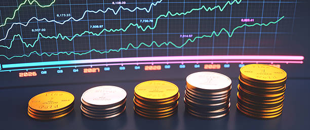 istock Close up on gold and silver coins with a defocused line graph in the background. 2253483067