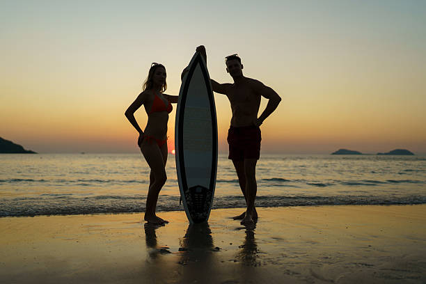 The couple enjoyed themselves on the beach at sunset.
