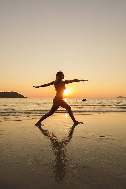 istock A beautiful girl in a bikini on the beach at sunset. 2253485404