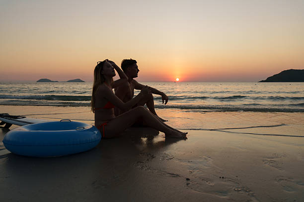 The couple enjoyed themselves on the beach at sunset.