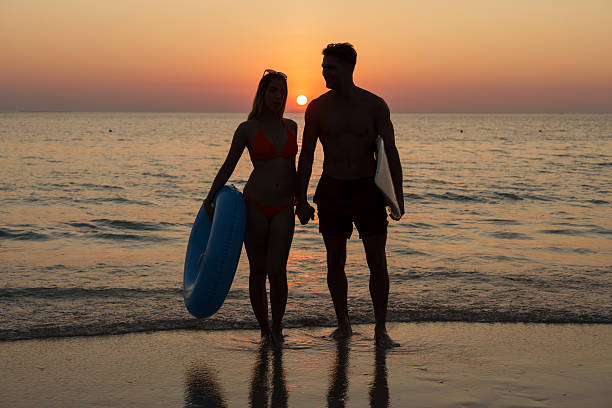 The couple enjoyed themselves on the beach at sunset.