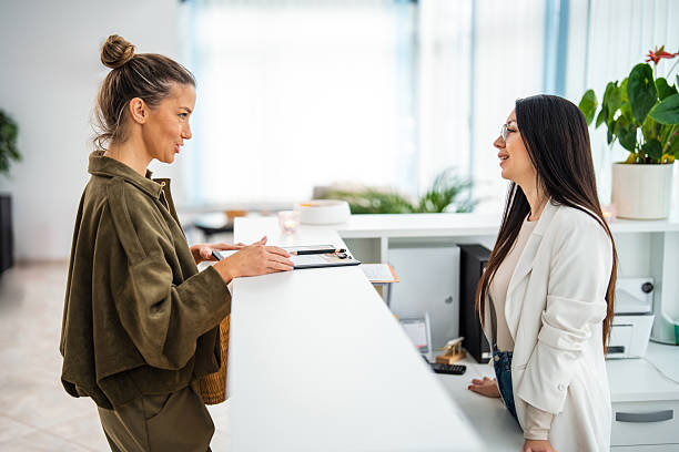 istock Delighted Caucasian Woman Engaging with Spa Receptionist Upon Arrival 2253486323