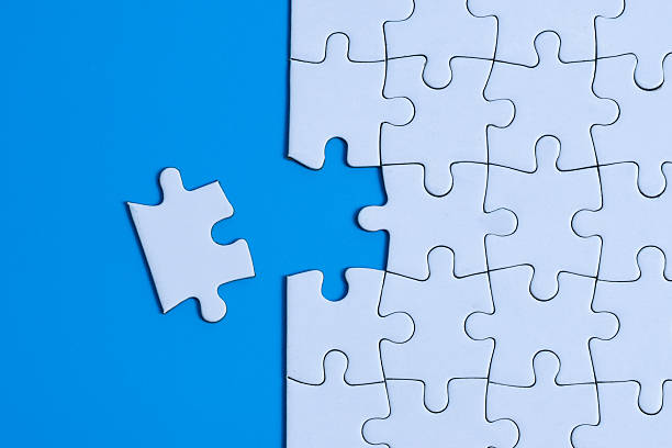 istock Task Completion Concept with Last white puzzle piece next to gap on blue background 2253487320