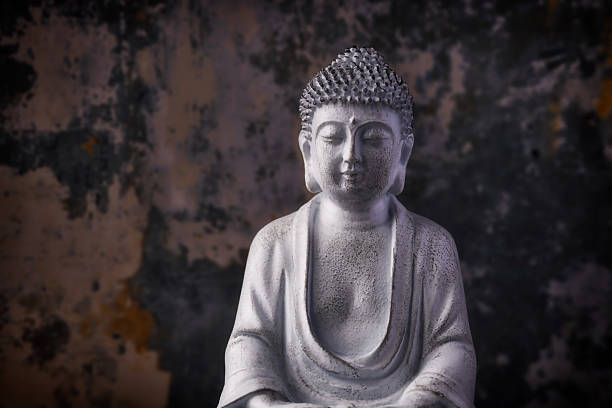 istock Meditating Buddha Statue on dark background. Close up. Copy space. 2253489923