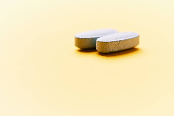 istock Multivitamin tablets on bright paper background. Close up. Copy space. 2253490114