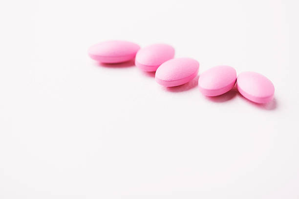 istock Multivitamin tablets on bright paper background. Close up. Copy space. 2253490285