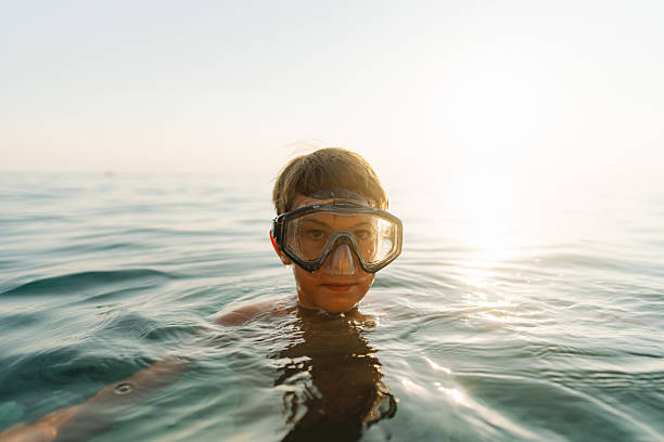 Photo of a young boy floating in the sea