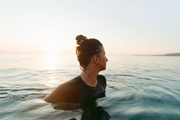 istock Swimming in the sunset 2253495334