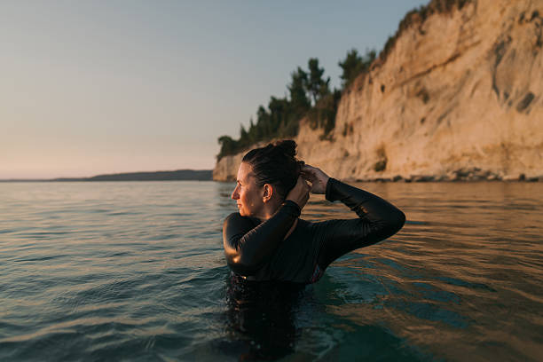 istock Swimming in the sunset 2253495344