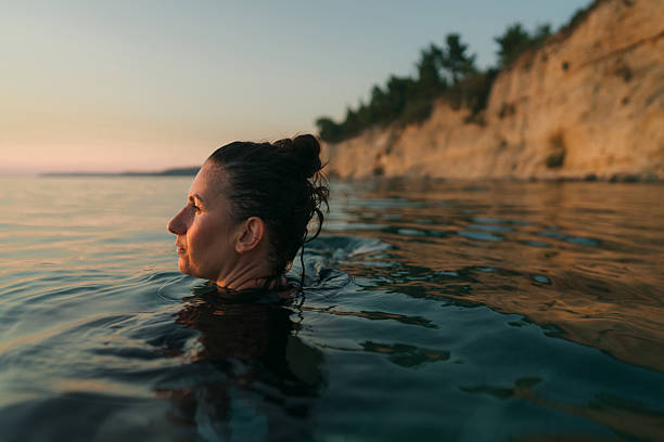 istock Swimming in the sunset 2253495365