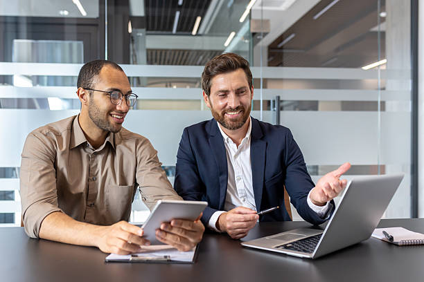 istock Two professionals collaborating on a business project in a modern office setting 2253495986