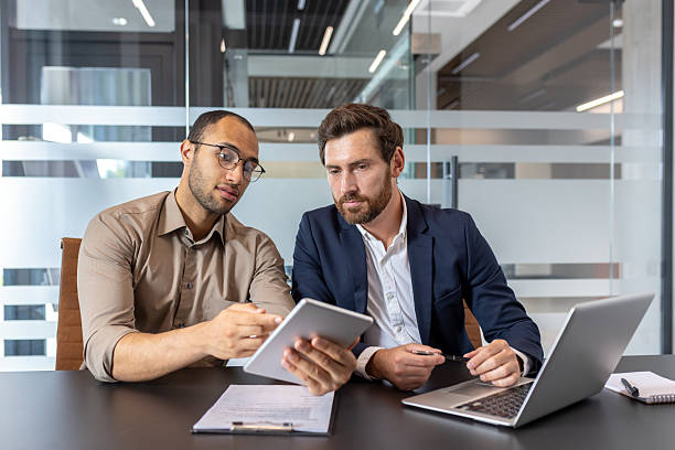 istock Business colleagues collaborating on a project in a modern office setting 2253495988