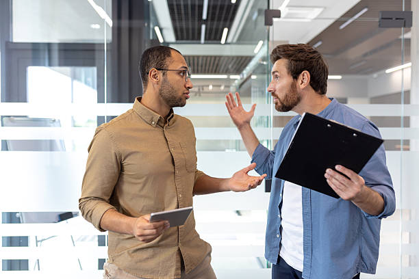 istock Office colleagues discussing a disagreement during a heated workplace conversation 2253496394
