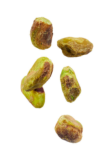 istock falling pistachios seeds isolated on white 2253501192