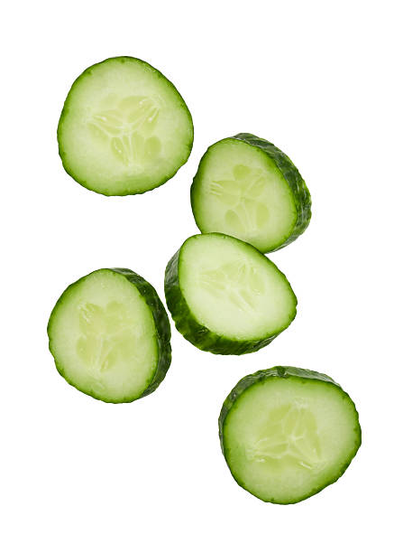istock falling slices of cucumber isolated on white 2253501205