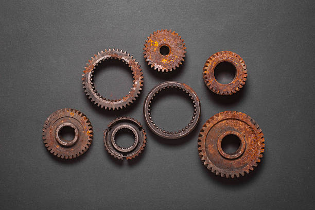 a set of old rusty gears on a black background