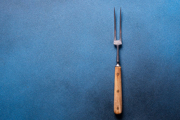 istock Meat fork on a blue background close-up top view 2253501479