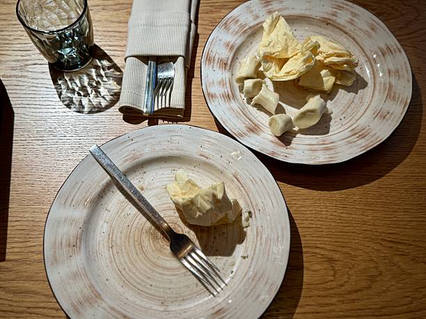istock Two Empty Plates With Fork Napkin, Overhead View, Glass And Cutlery, Rustic Wood Tabletop, Mild Crumbs, Intimate Setting Suggesting Companionship, Soft Ambient Glow, Lingering Conversation 2253501635