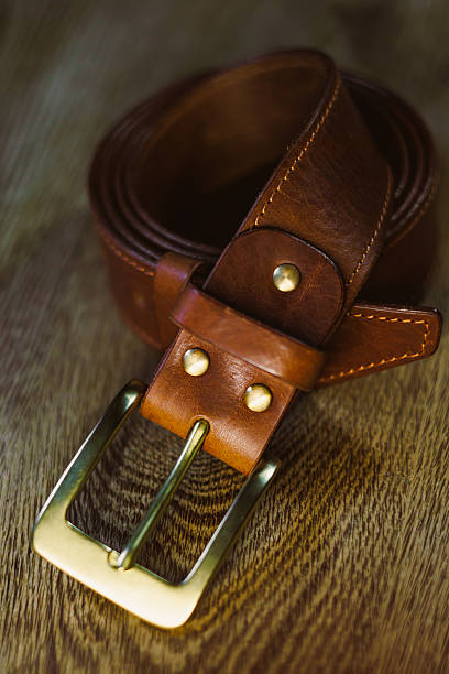 istock Explore a beautifully crafted brown leather belt featuring a classic golden buckle, designed with the discerning fashion enthusiast in mind, aiming to elevate the look of any outfit gracefully 2253502752