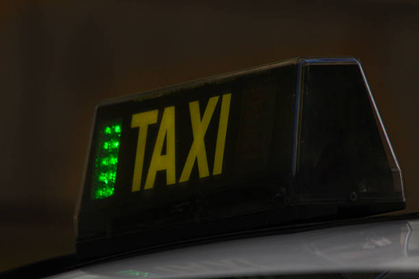 Taxi sign on car at night. Santiago de Compostela, Galicia, Spain.
