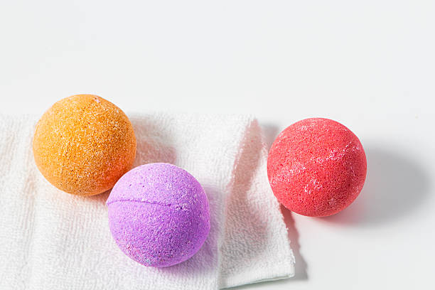 istock Colorful bath bombs on a towel showcasing various shades and textures in a simple setting 2253504547
