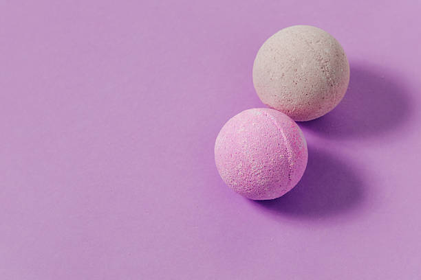 istock Two round bath bombs on a purple background ready for use in a relaxing bath experience 2253504550