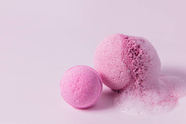 istock Bath bombs on a light surface with colorful foam and bubbles in a relaxing setting 2253504558