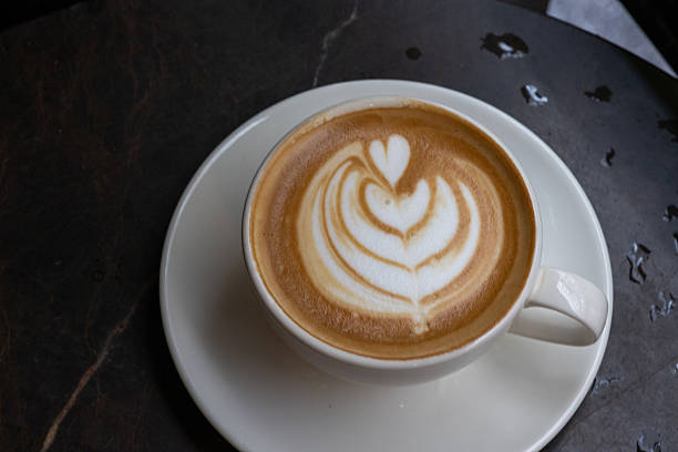 Close-up of cappuccino in white cup in high light