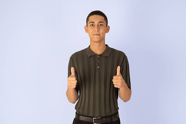 Man in dark polo showing thumbs up.