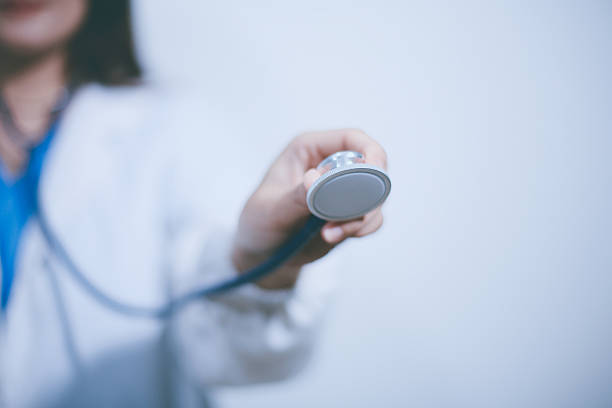 A young male doctor holding an stethoscope