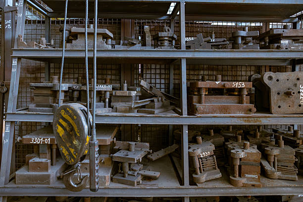 A collection of tools with orange handles and black handles are displayed. orange handles are positioned on the left side of row, while black handles are on right side