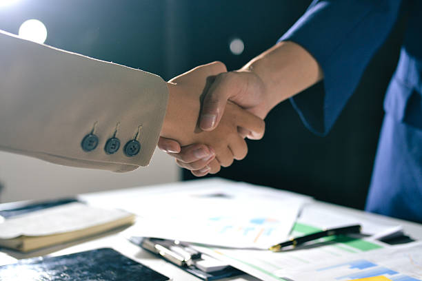 Handshake in contemporary office space