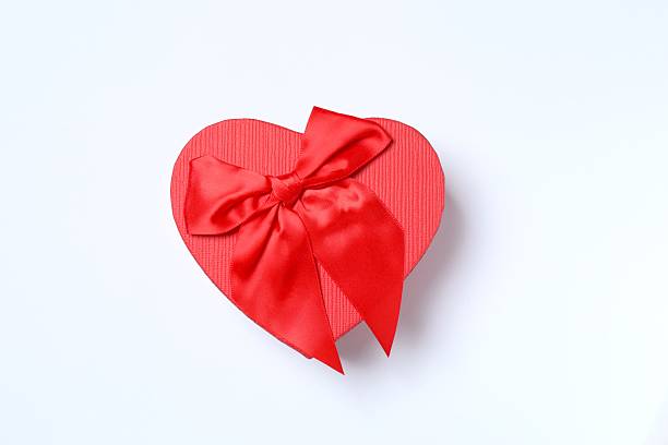 istock Festive gift box with red hearts on white background 2253521255