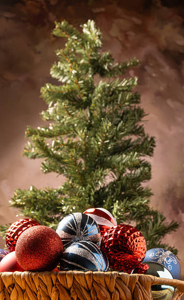 istock Christmas tree, a beautiful empty Christmas tree with colorful balls in a basket in front of it, abstract background, selective focus. 2253524744