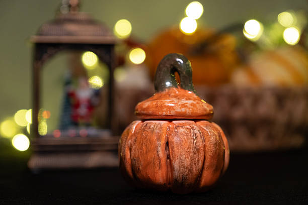 Ceramic pumpkin ornament. Christmas themed design.