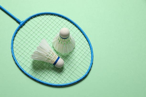 istock Badminton racket and white badminton shuttlecocks on color background 2253525230