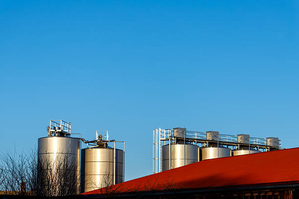 Group of Latin American workers talking in a circle at a brewery factory â industrial concepts