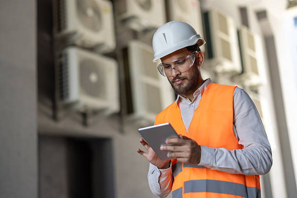 istock An engineer in safety gear reviews data on a tablet while working on a project outside. 2253525532