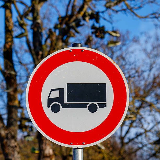 Round prohibitory sign showing a black truck symbol on a white background