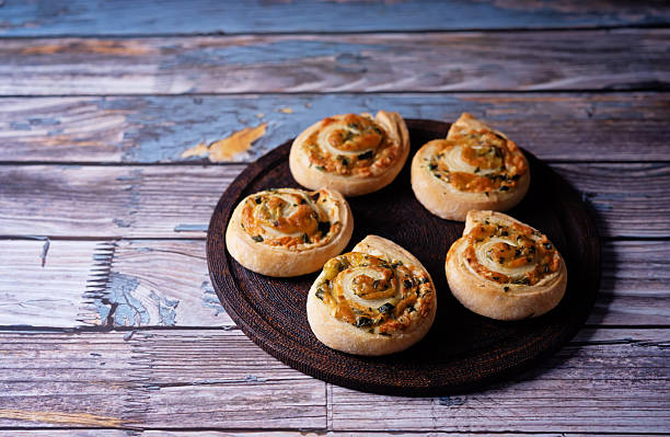 istock Basil garlic cheese roll cake pinwheel in a plate on a wood background 2253526476