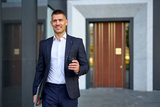 istock Businessman enjoying coffee walking from office building 2253528254