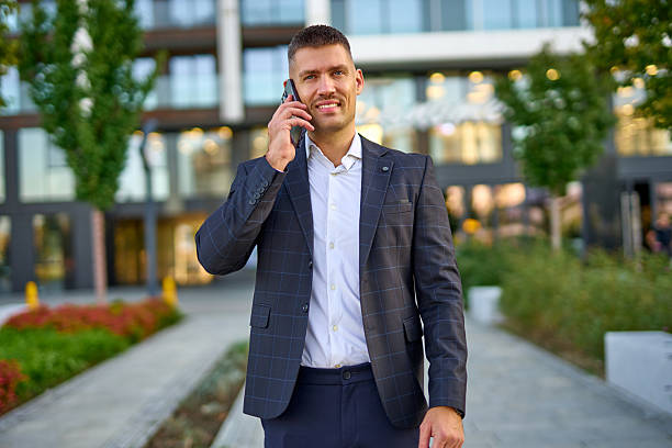 istock Businessman talking on smartphone in urban setting 2253528255