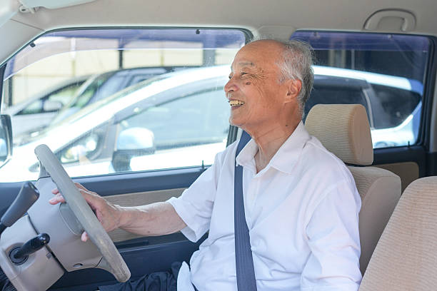 istock An old man is driving a car and smiling 2253530789
