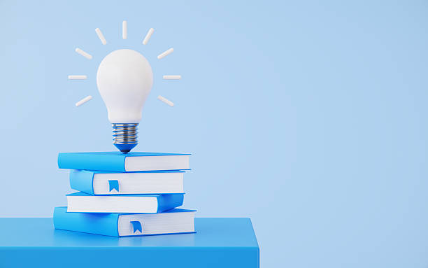 istock White Light Bulb on Same Color Books Over Blue Background 2253534395