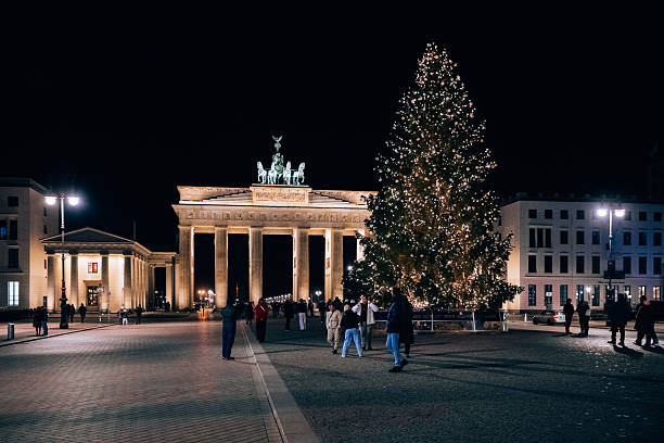 Berlin, Germany – December 24, 2025: An illuminated Christmas tree at Pariser Platz with the Brandenburg Gate visible in the background.