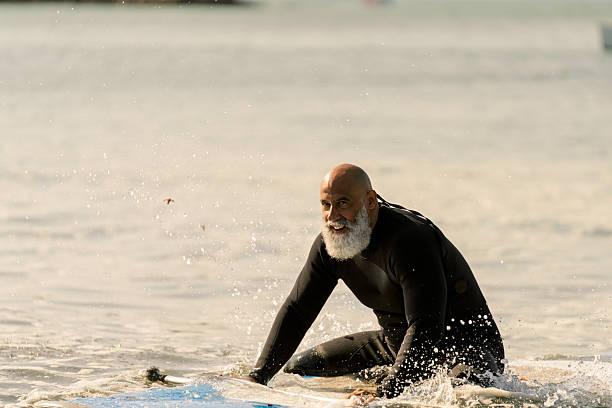 istock Senior adult man paddleboarding on ocean waves 2253536362