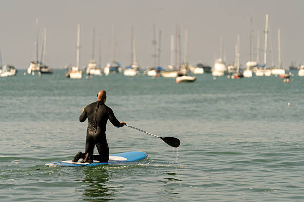 Woman Paddleboarding on a Lake Summertime